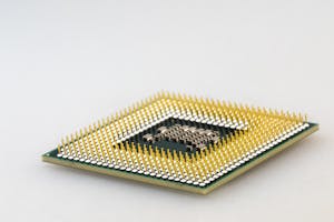 Close-up of a CPU microchip with gold pins.