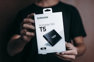 Person holding a portable SSD box.